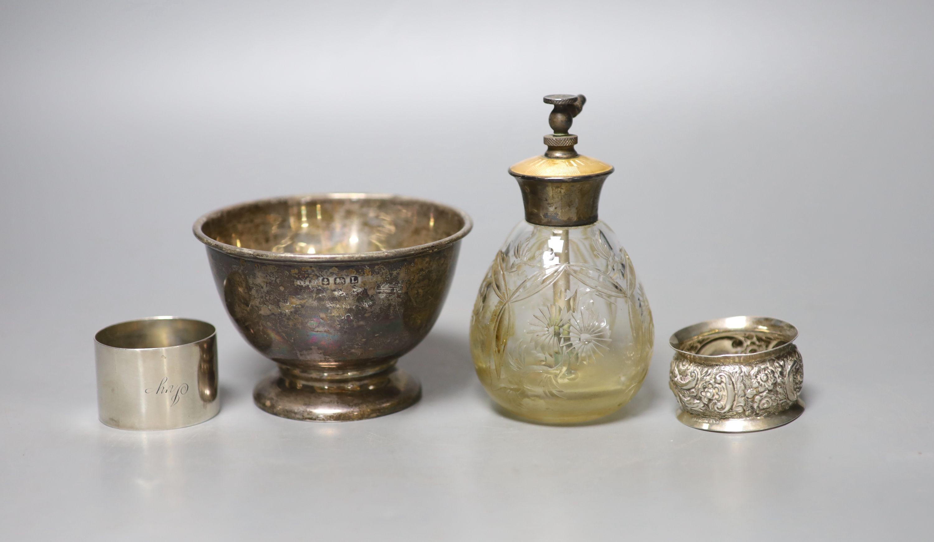 A 1930's silver sugar bowl, two silver napkin rings and a sterling and enamel mounted glass atomiser.